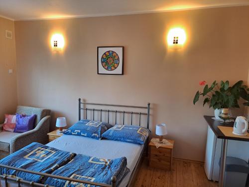 a bedroom with a bed and a chair and lights at Willa Słoneczna - Magdalena i Michał Żelewscy in Karwieńskie Błoto Pierwsze