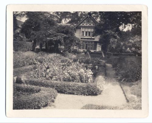 a black and white photo of a house with a garden at The Baker House 1650 in East Hampton