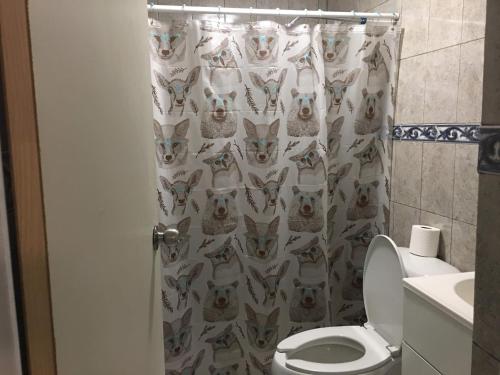 a bathroom with a shower curtain with dogs on it at Lindo departamento con 2 cuartos y excelente ubicacion. in Hermosillo