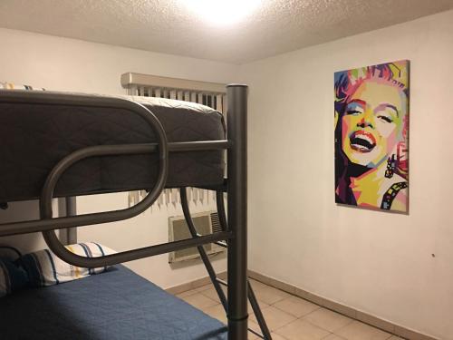 a bunk bed in a room with a painting on the wall at Lindo departamento con 2 cuartos y excelente ubicacion. in Hermosillo