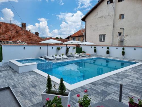 a swimming pool in the backyard of a house at Fenix Apartments in Soko Banja