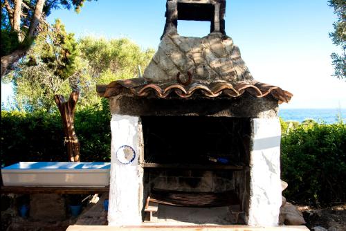 a stone oven with a roof at Splendida villa in riva al mare in Orosei