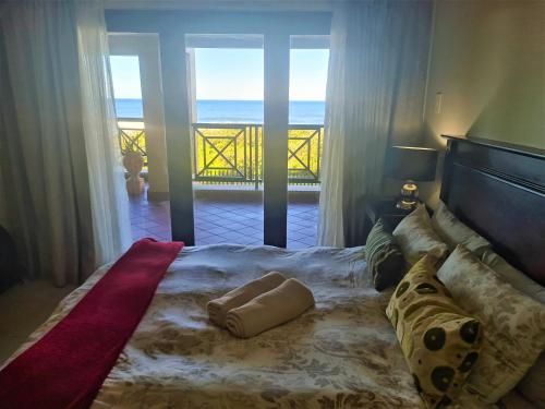 a bedroom with a bed with a view of the ocean at Bondi Beach 64 in Margate