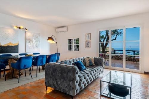 a living room with a couch and a table at Casa Trevelyan Isola Bella in Taormina