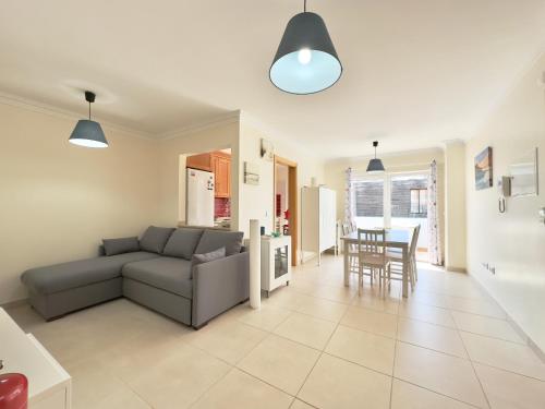 a living room with a couch and a table at Baleal Happy Family Apartment in Ferrel