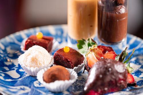a blue plate topped with different types of desserts at InterContinental Porto - Palacio das Cardosas by IHG in Porto