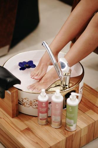 a person getting their feet washed in a sink at Xheko Imperial Luxury Hotel & SPA in Tirana