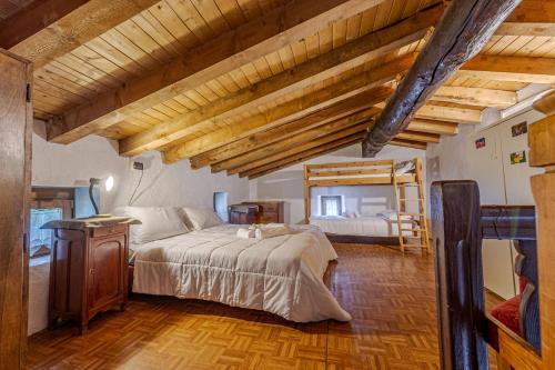a bedroom with a large bed and a bunk bed at Baita Margherita - Val Veny in Courmayeur