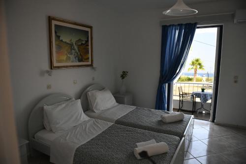 - une chambre avec un lit, un canapé et une fenêtre dans l'établissement MIMIS APARTMENTS, à Kefalos