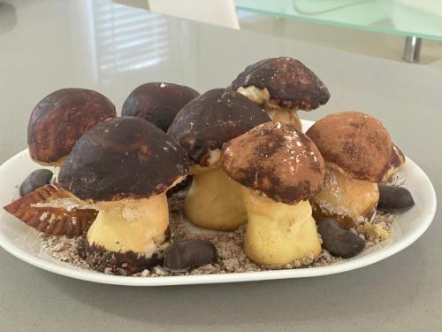 a plate of chocolate coveredcovered mushrooms on a table at Villa Marina B&B in Cleto
