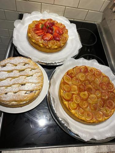 three pizzas sitting on top of a stove at Villa Marina B&B in Cleto