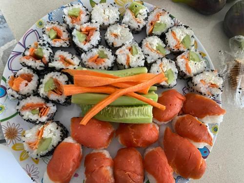 a plate of sushi and rolls on a table at Villa Marina B&B in Cleto