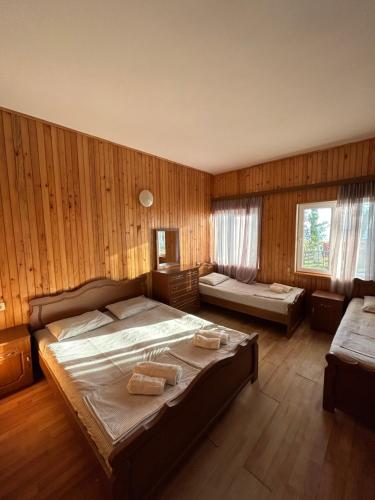 a bedroom with a large bed with towels on it at EVRIKA hotel Shekvetili in Shekvetili