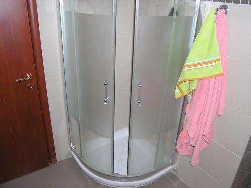 a shower with a glass door and a towel at Beach View Siviri in Siviri