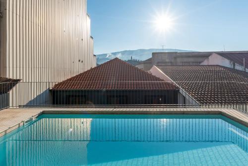 a swimming pool on the roof of a building at Feel Discovery Homes in Douro in Peso da Régua