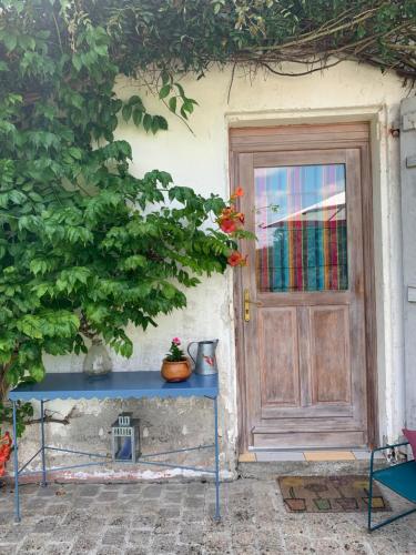 a house with a blue table in front of a door at Gîte La Louisiane in Salies-de-Béarn