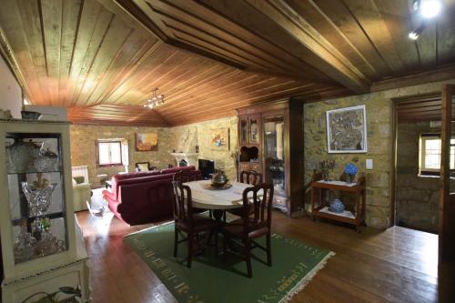 a living room with a table and a couch at Casa da Ramada, Turismo Espaço rural. in Ponte de Lima