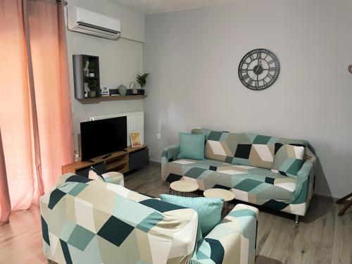 a living room with two couches and a tv at Nikolas Apartment in Alexandroupoli