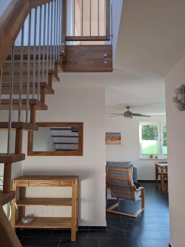 a living room with a staircase and a table at Ferienwohnung Pappelwende in Ostseebad Karlshagen
