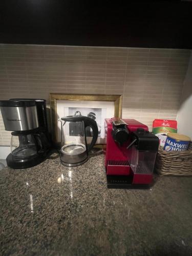 a counter top with a coffee maker and a blender at شقة الاحلام in King Abdullah Economic City