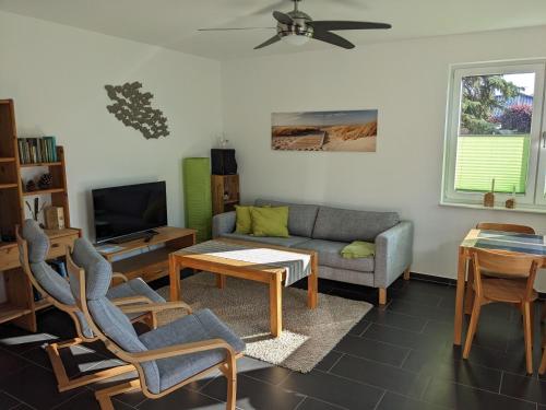 a living room with a couch and a table at Ferienwohnung Pappelwende in Ostseebad Karlshagen