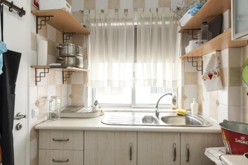 a kitchen with a sink and a window at Horizonte - Sea view by HD PROPERTIES in Quarteira
