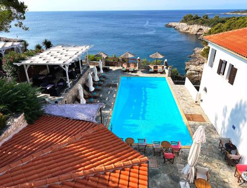 a swimming pool with a view of the ocean at Yalis Hotel in Votsi