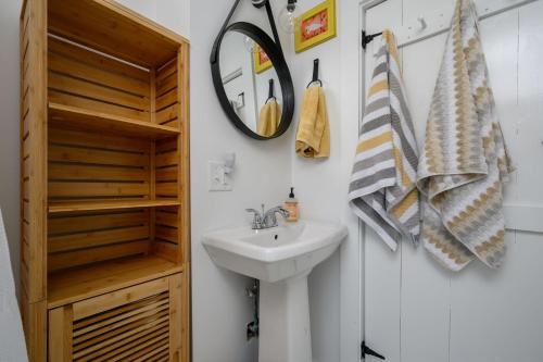 a bathroom with a sink and a mirror at 79 West Road Orleans Cape Cod - Bed Splash & Beyond in Orleans