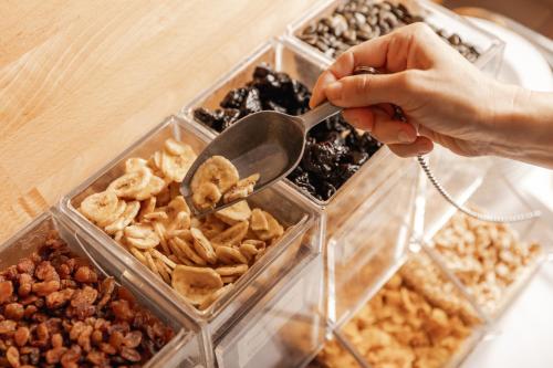 a person holding a spoon over a tray of food at Landhotel Stofflerwirt in Sankt Michael im Lungau