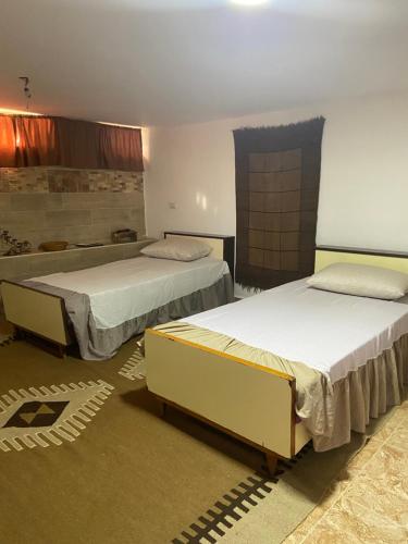 a room with two beds in a room at Simple home in Madaba