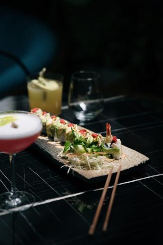 a couple of sandwiches on a table with a drink at Xheko Imperial Luxury Hotel & SPA in Tirana