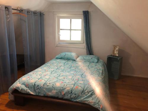 a bedroom with a bed and a window at Le clos de la Marniere in Ecques