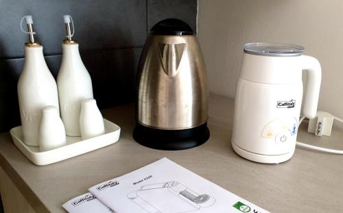 a counter with a coffee maker and bottles on it at RB Della Torre in Porretta Terme