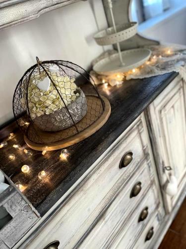 a basket of grapes on top of a dresser with lights at Grotta dei Puntali B&B in Carini