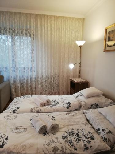 a bedroom with two beds with towels on them at Virágos Vendégház Balatonfüred in Balatonfüred