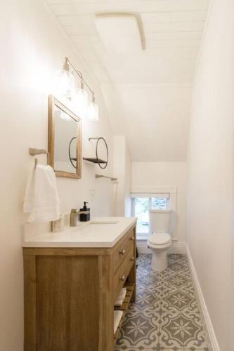 a bathroom with a sink and a toilet at Waterfront with Hot Tub Joanie's Farmhouse in Bath