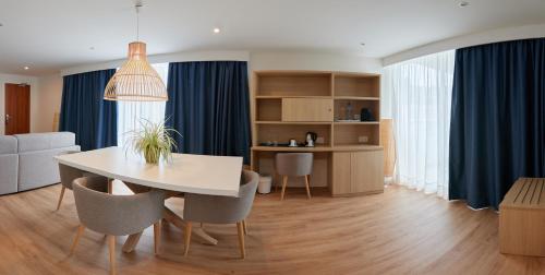 a living room with a white table and chairs at Los Geranios in Port de Soller