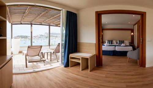 a hotel room with a bedroom with a bed and a balcony at Los Geranios in Port de Soller