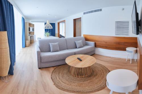 a living room with a couch and a table at Los Geranios in Port de Soller