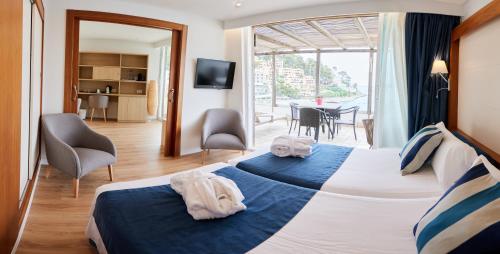 a hotel room with a bed with towels on it at Los Geranios in Port de Soller