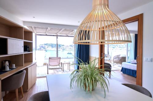 a kitchen and dining room with a table and a potted plant at Los Geranios in Port de Soller