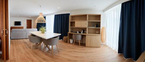 a kitchen and dining room with a table and chairs at Los Geranios in Port de Soller