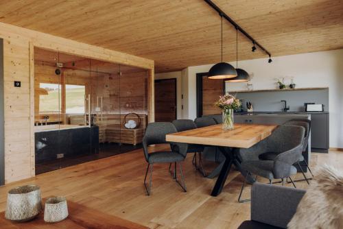 a kitchen and dining room with a wooden table and chairs at Platzhirsch Ofterschwang in Ofterschwang
