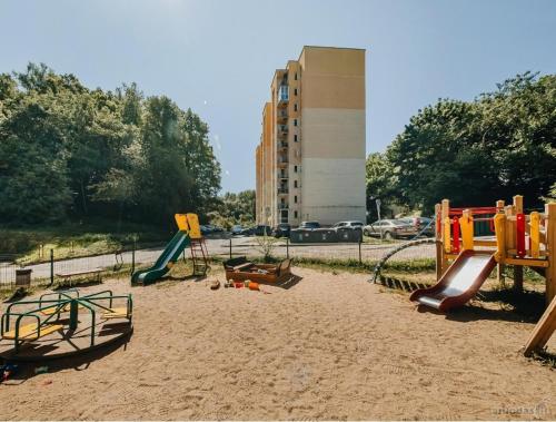 a playground in a park with slides and play equipment at Green Vilnius Getaway in Vilnius