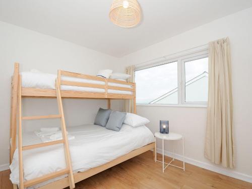 a bedroom with bunk beds and a window at Westcroft 6 Withnoe Terrace in Torpoint