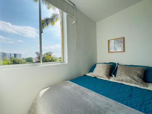 1 dormitorio con cama y ventana grande en Full furnished apartment in Pereira, en Pereira