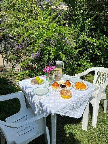 a white table with plates of food on it at Villa Marina B&B in Cleto