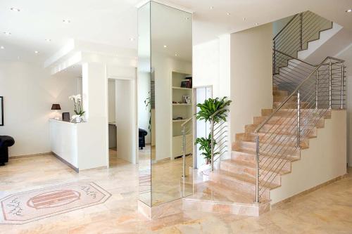 a staircase in a house with a glass wall at Hotel Europa in Alessandria