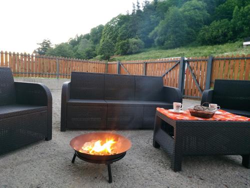 a patio with a fire pit and couches and a table at Villa Bayern in Bakuriani in Bakuriani