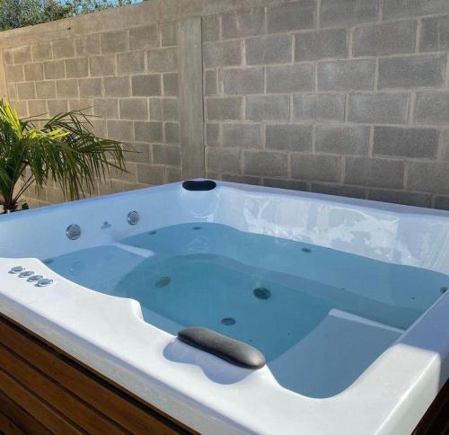 a jacuzzi bathtub with a blue at Cañas Suites Villa Cura Brochero in Villa Cura Brochero